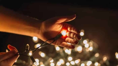 hand holding christmas lights