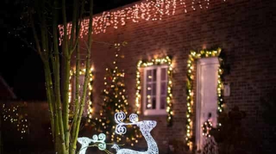 home with Christmas lights and light up deer