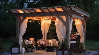 gazebo with hanging lights and curtains