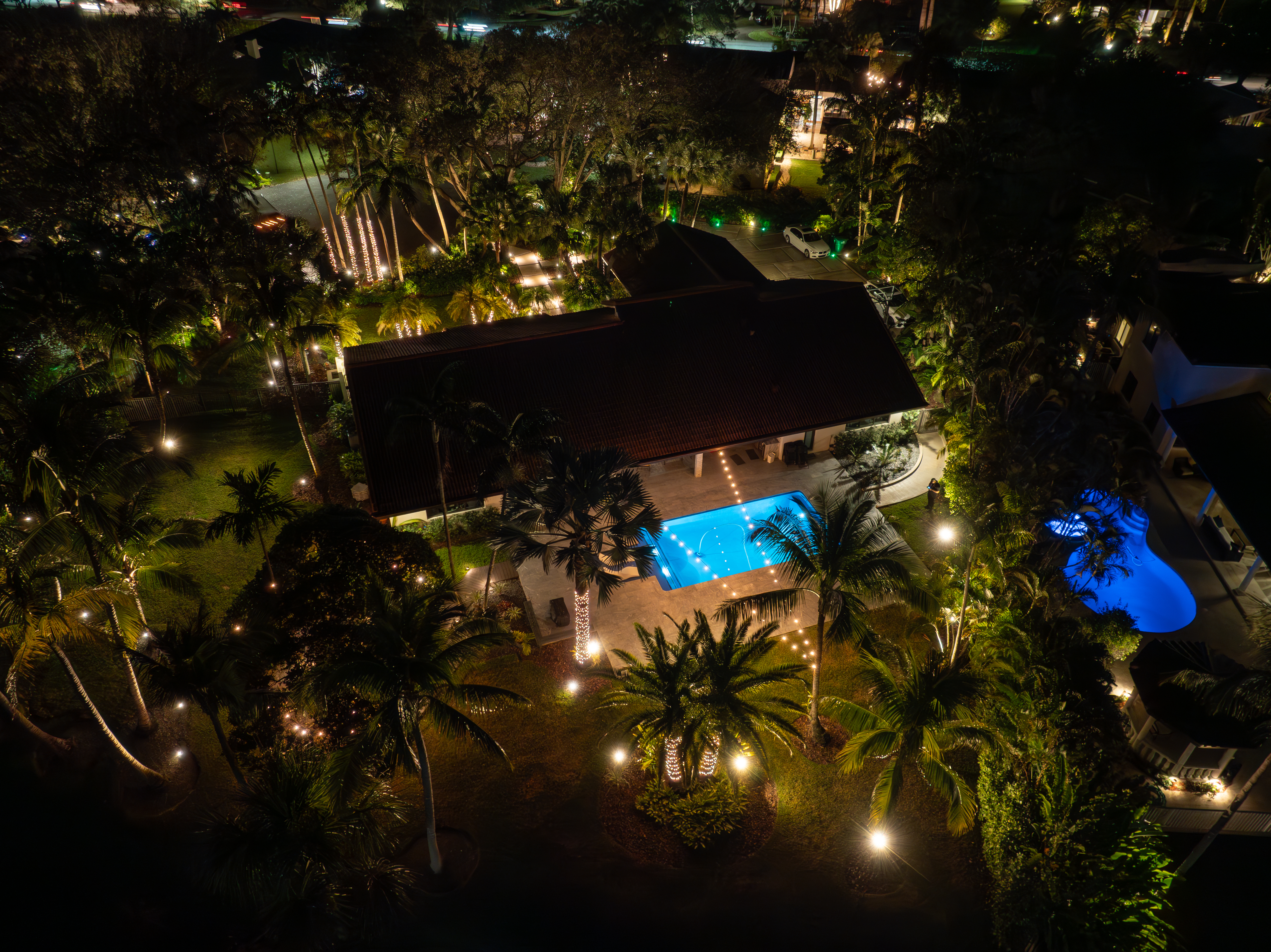 An aerial shot of a lit backyard