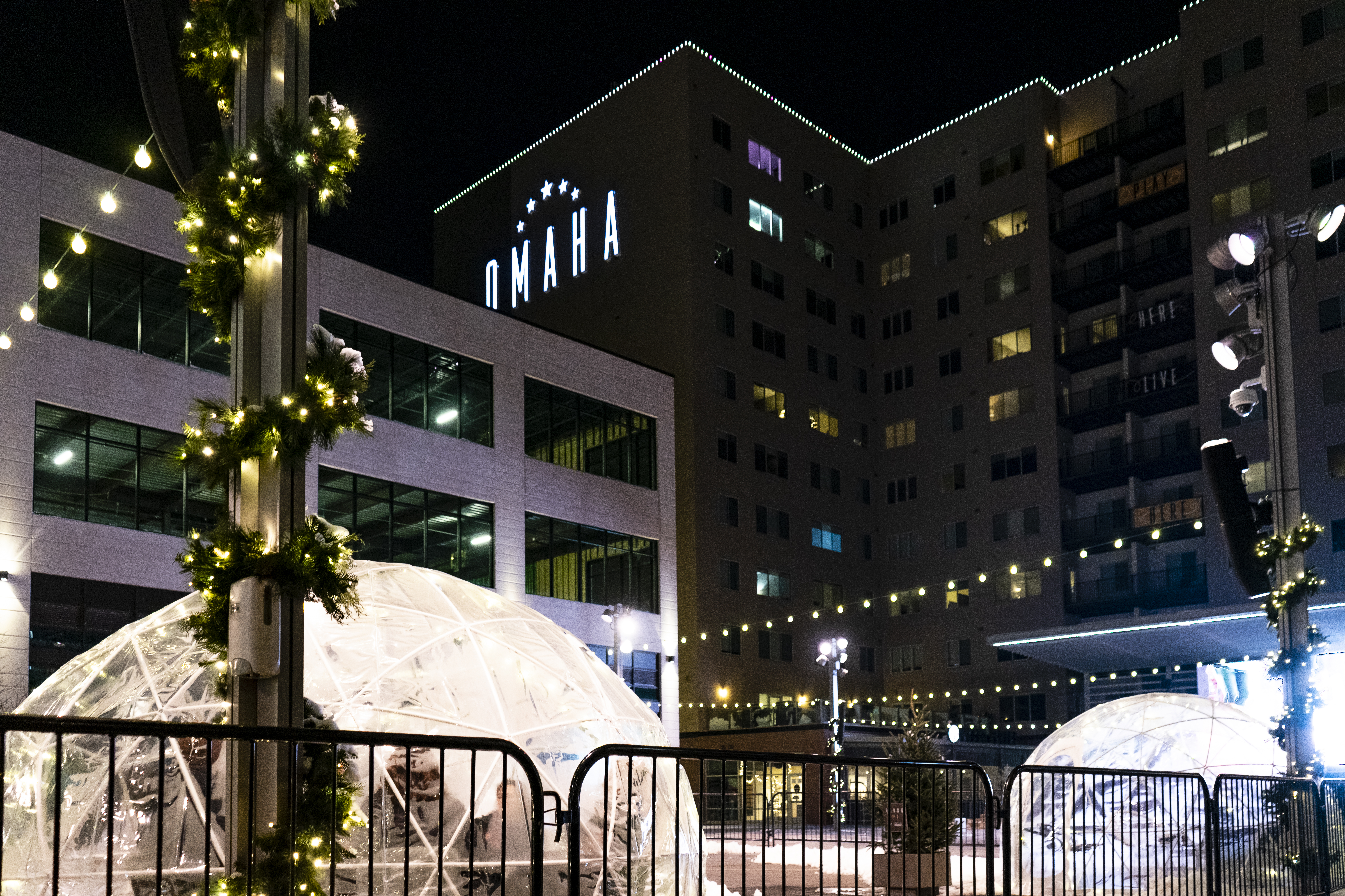 Holiday Lighting on roofline of building plus garland on pillars