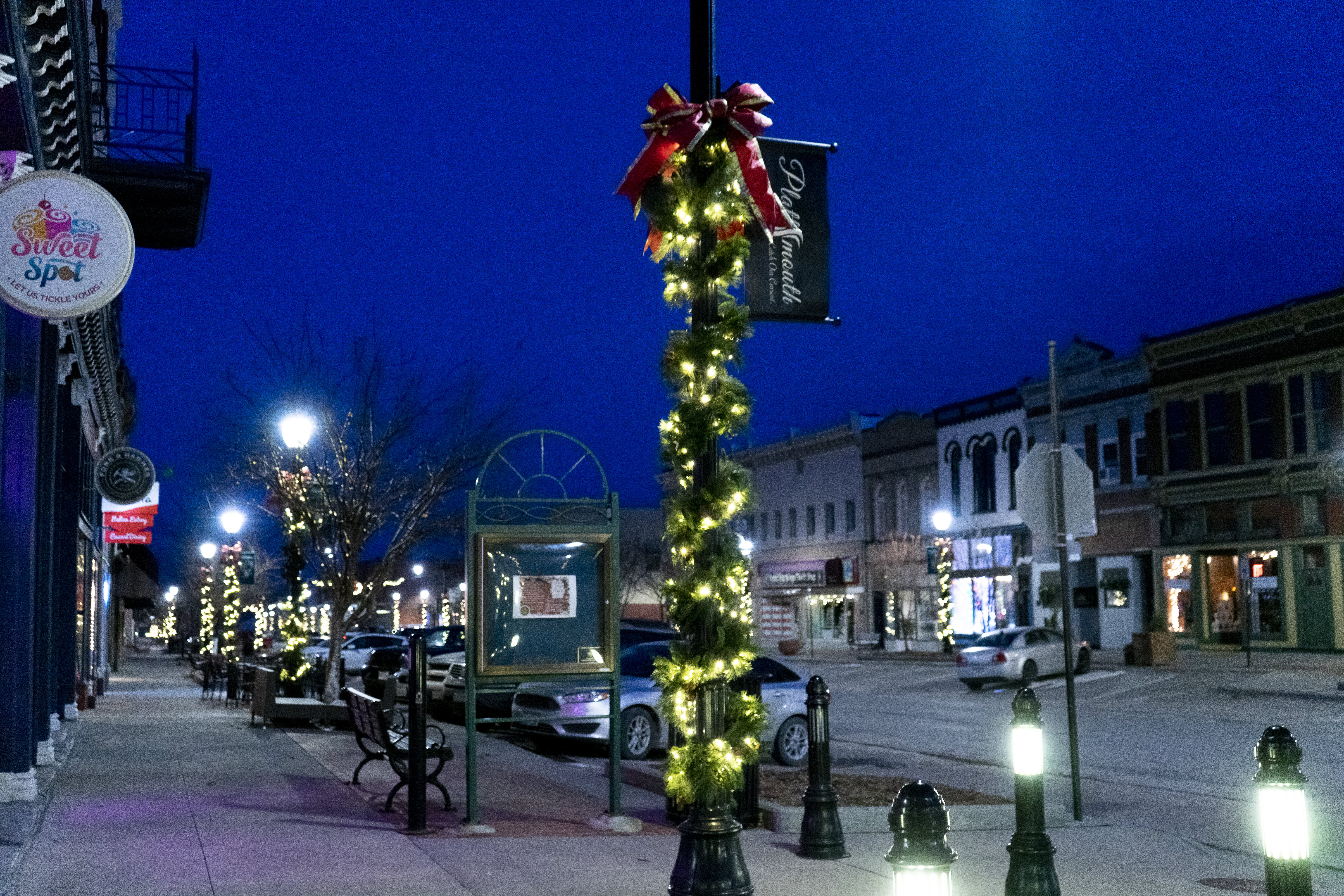 Greenery and bows with lights on lightpoles