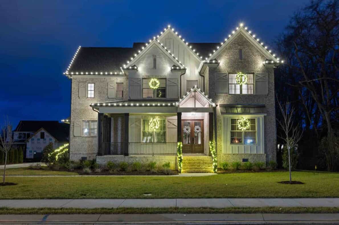 home with Christmas lights and lighted garland