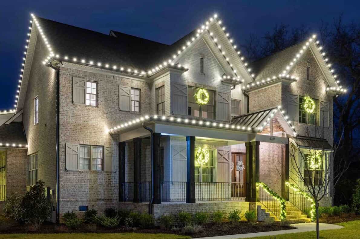home with white Christmas lights and lighted garland