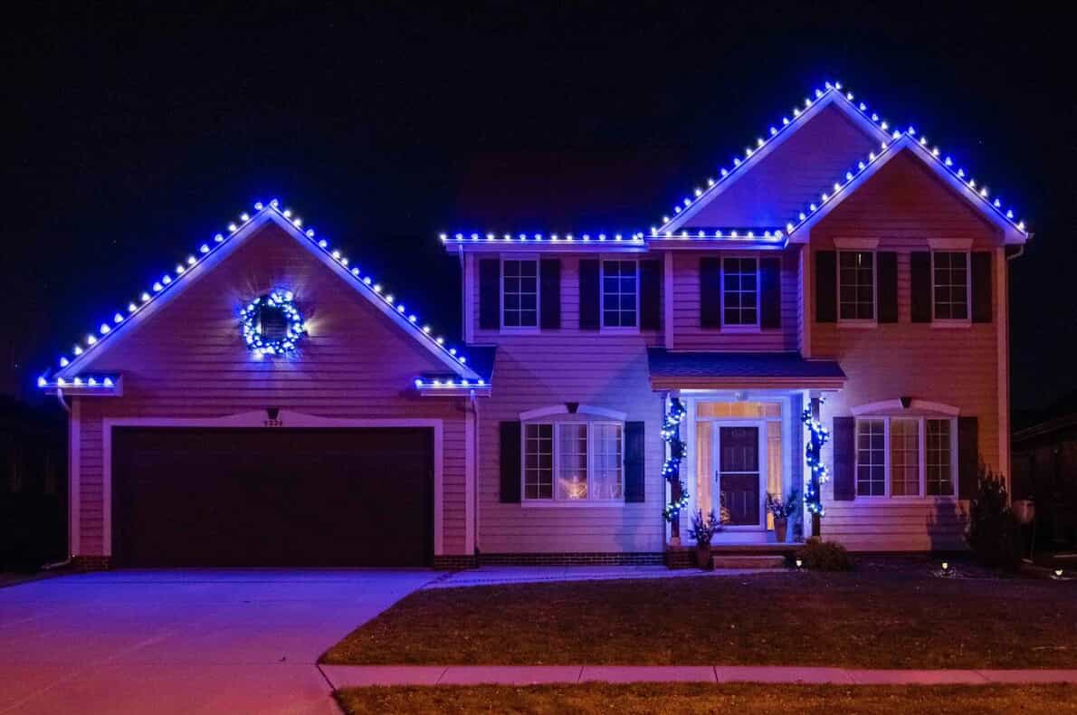 multicolored blue lights on house with lighted wreath
