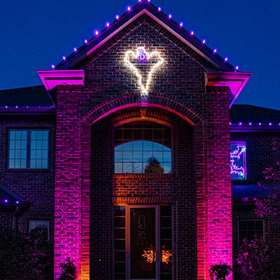 large home with multicolored lights on exterior