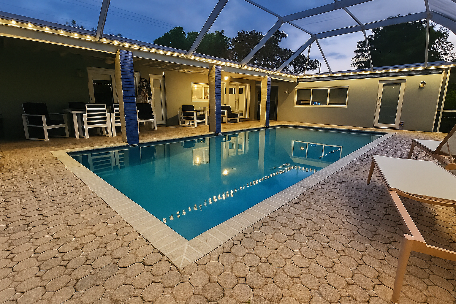 An indoor pool with string lighting