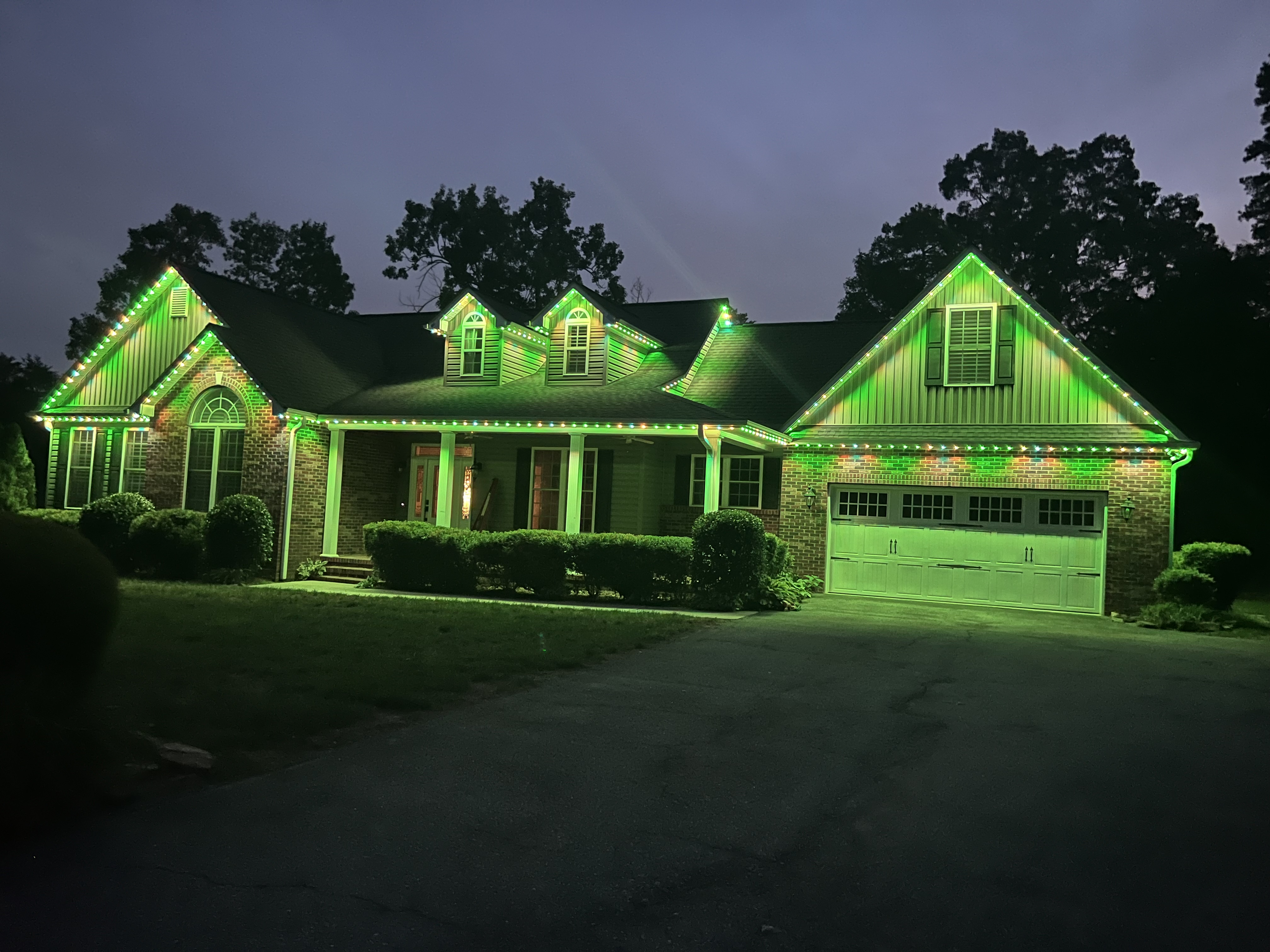 Permanent LED holiday lighting on a two-story home
