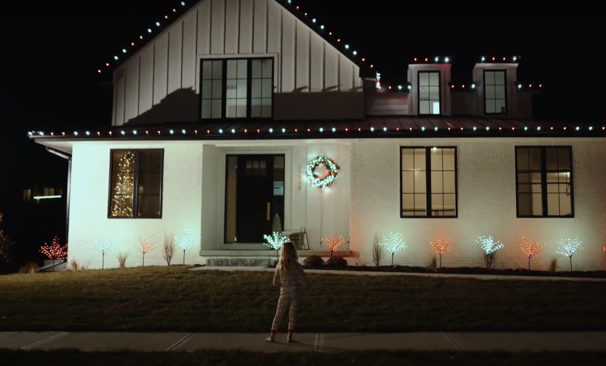 a child looking at holiday lights