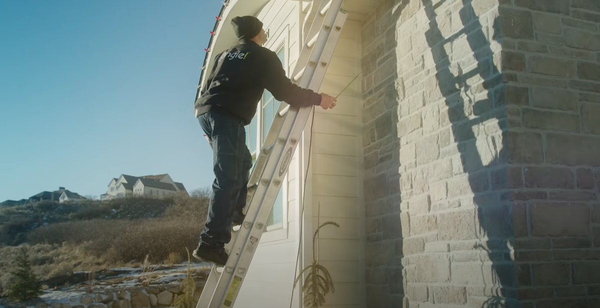 Man setting up holiday lights