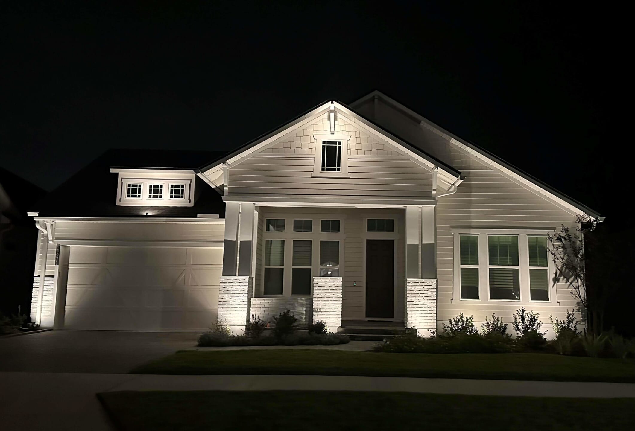 white home with custom outdoor lighting