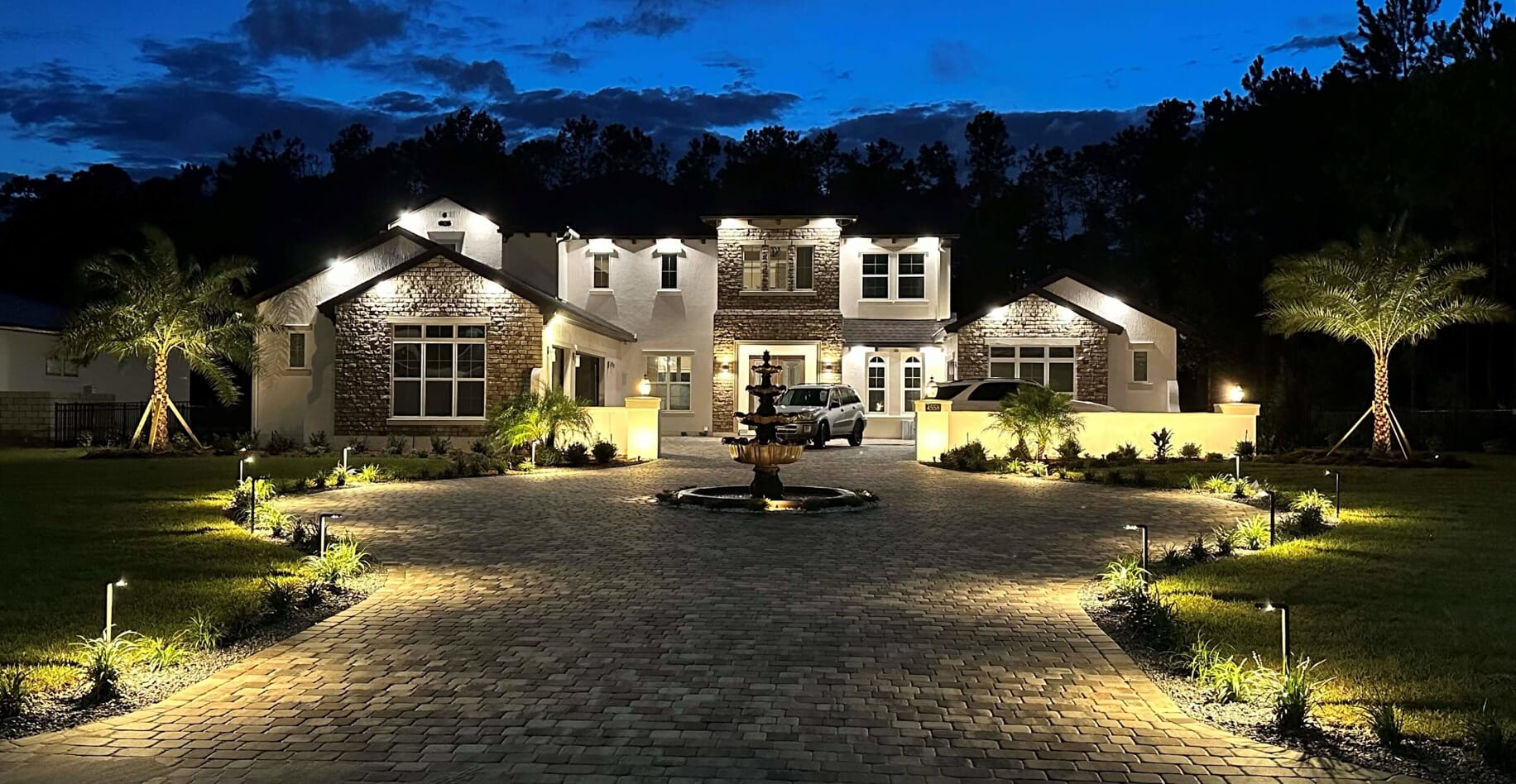 large home with custom outdoor lighting
